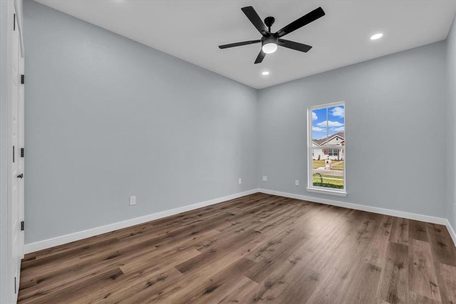 Spare room featuring wood finished floors, recessed lighting, and a ceiling fan Spare room featuring wood finished floors, recessed lighting, and a ceiling fan