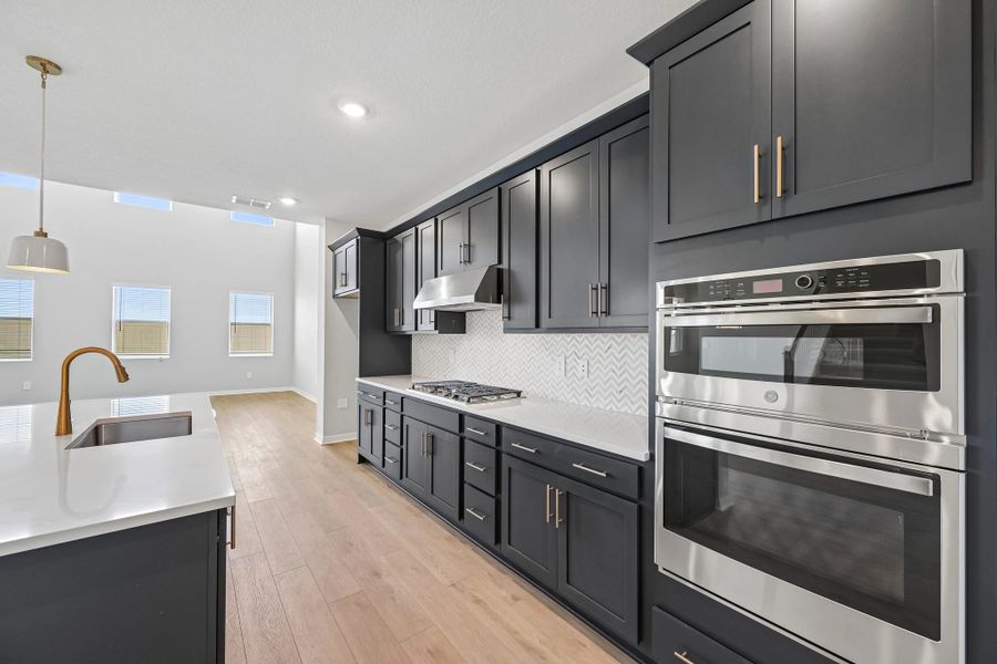 You will continue into this stunning kitchen featuring aspects of AW Collection® Sapphire with a double stack oven and microwave