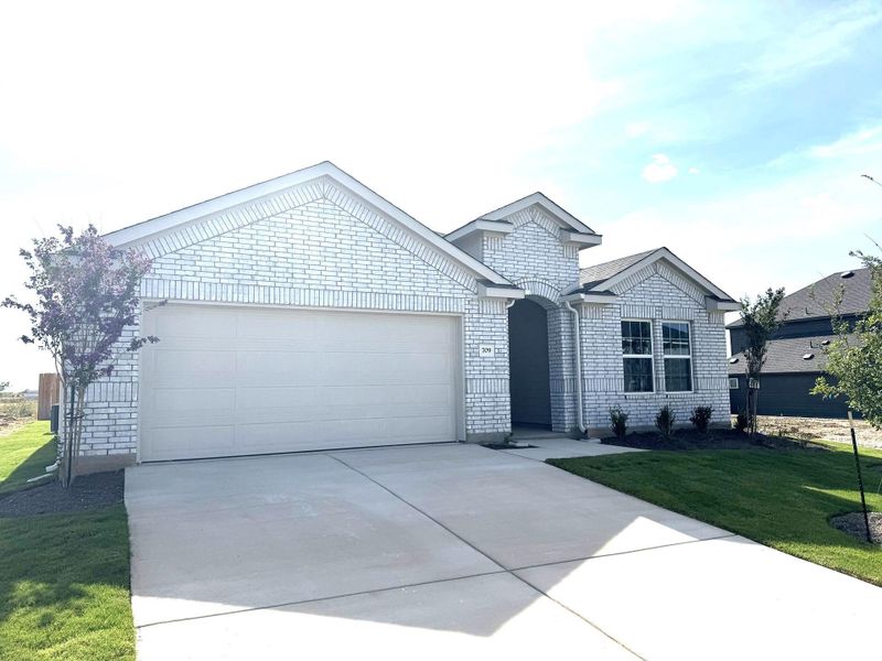 Front exterior of a new home in Hunters Glen, Jarrell, TX, highlighting curb appeal (Image 2). Front exterior of a new home in Hunters Glen, Jarrell, TX, highlighting curb appeal (Image 2).