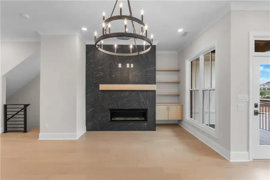 Contemporary fireplace with dark-toned surround, light wood mantel, and built-in shelving