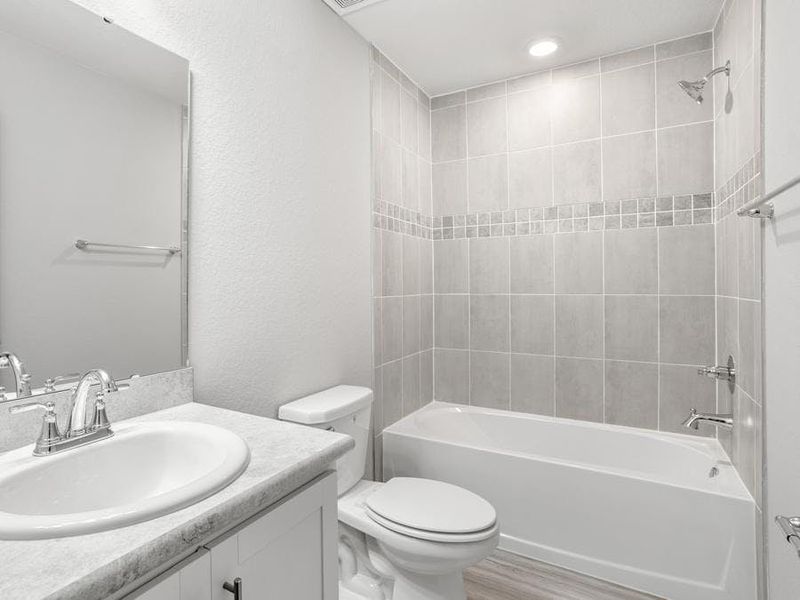 Secondary bedrooms share an upstairs hall bath, and a downstairs powder room serves guests - Blakely by Highland Homes Secondary bedrooms share an upstairs hall bath, and a downstairs powder room serves guests - Blakely by Highland Homes