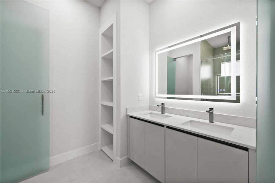 Bathroom with double vanity, a shower stall,and a closet Bathroom with double vanity, a shower stall,and a closet