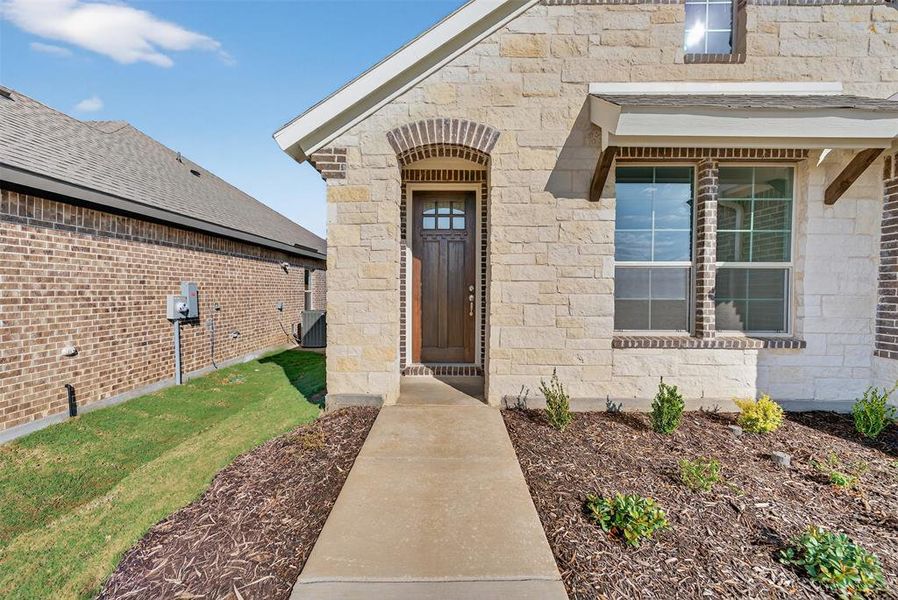 View of exterior entry featuring stone siding