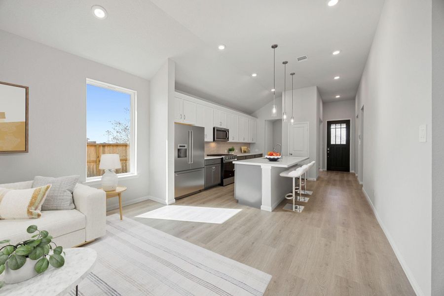 This living space is thoughtfully designed with a soaring vaulted ceiling that enhances the feeling of openness. The ambiance is perfectly controlled by ample recessed lighting installed throughout the area. Natural light floods the room through the expansive large window, creating a warm atmosphere. This living space is thoughtfully designed with a soaring vaulted ceiling that enhances the feeling of openness. The ambiance is perfectly controlled by ample recessed lighting installed throughout the area. Natural light floods the room through the expansive large window, creating a warm atmosphere.