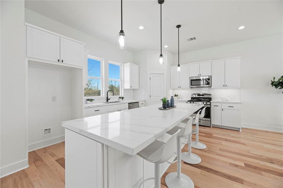 The long kitchen island is perfect for casual meals or visiting with guests while the chef whips up something delicious.