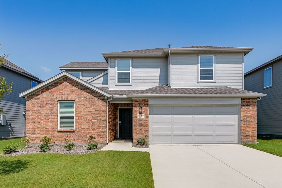 Front exterior of a new home in River Ridge, Crandall, TX, highlighting curb appeal (Image 1). Front exterior of a new home in River Ridge, Crandall, TX, highlighting curb appeal (Image 1).