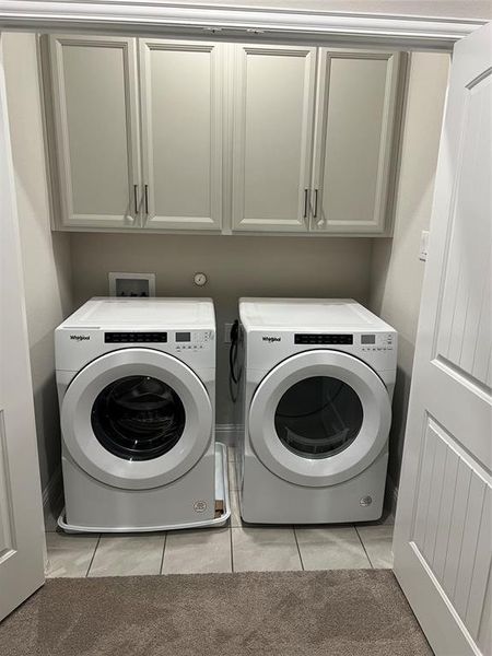 Laundry utility room with built in cabintes, lighting and a washer and dryer that can convey to the new buyer - View