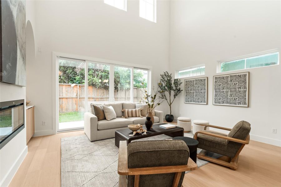 Leaving your kitchen/dining area, enter the living room. This rare to find 24' ceiling makes your home feel massive, with windows and double sliding door allowing in ample sunlight. Leaving your kitchen/dining area, enter the living room. This rare to find 24' ceiling makes your home feel massive, with windows and double sliding door allowing in ample sunlight.