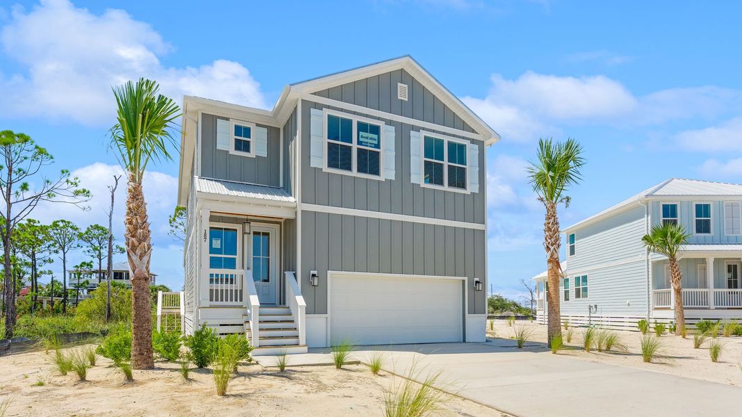 Front exterior of a new home in Redfish Cove at Cape San Blas, Port Saint Joe, FL, highlighting curb appeal (Image 1). Front exterior of a new home in Redfish Cove at Cape San Blas, Port Saint Joe, FL, highlighting curb appeal (Image 1).