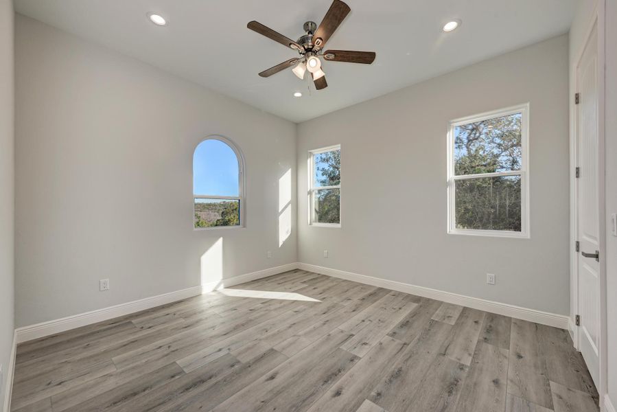 Empty room featuring light wood finished floors, recessed lighting, and ceiling fan