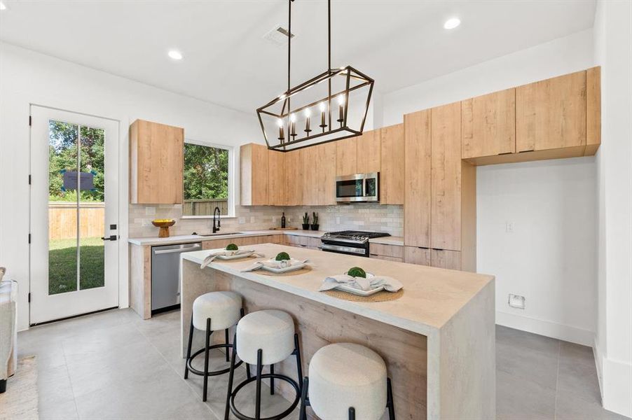 Arcadia Yellow Walnut cabinetry with Artic White with Coral Luster Quartz Countertops.