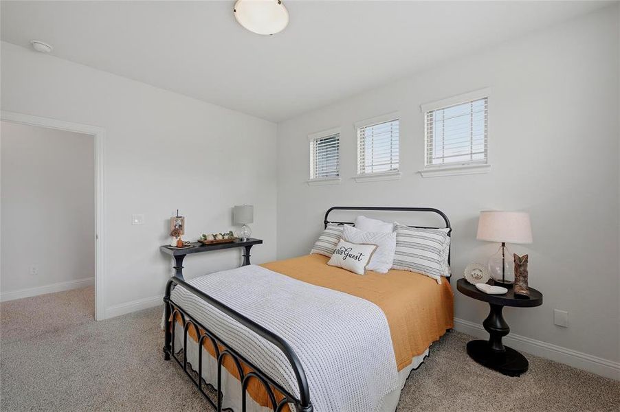 Bedroom with light grey textured carpeting and white walls