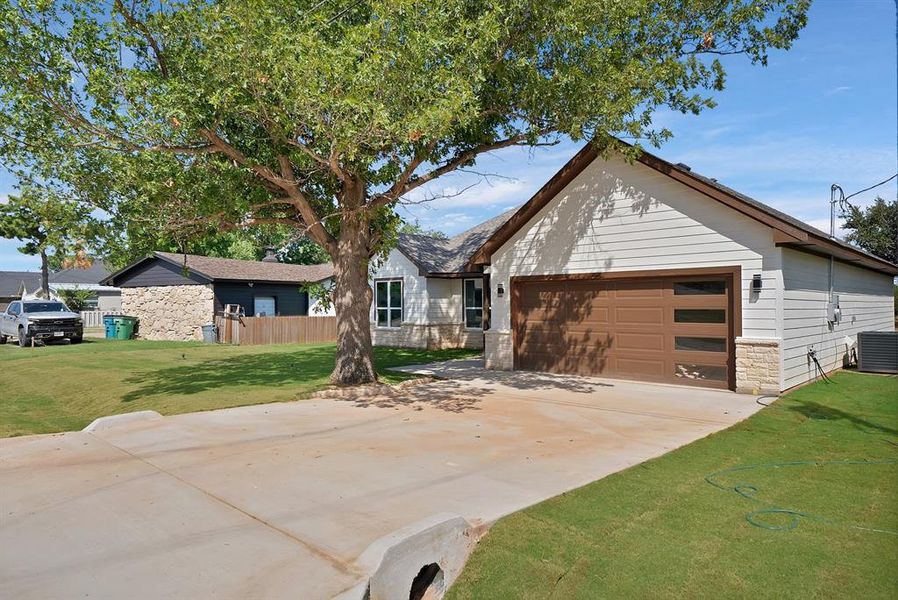 Front exterior of a new home in , Runaway Bay, TX, highlighting curb appeal (Image 15). Front exterior of a new home in , Runaway Bay, TX, highlighting curb appeal (Image 15).