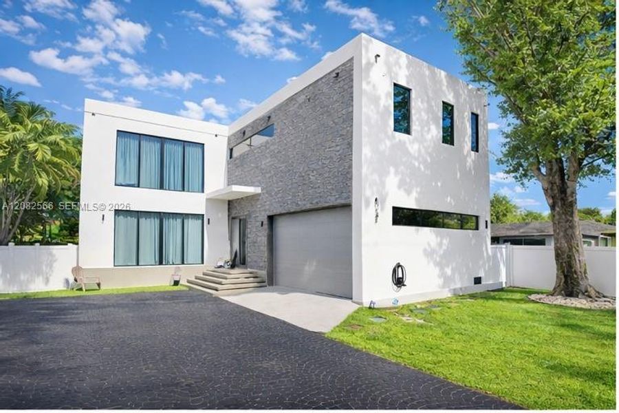 Front exterior of a new home in , Dania Beach, FL, highlighting curb appeal (Image 1). Front exterior of a new home in , Dania Beach, FL, highlighting curb appeal (Image 1).