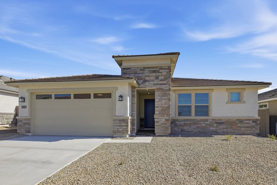 Front exterior of a new home in Montana Vista - Summit: Summit, Buckeye, AZ, highlighting curb appeal (Image 1). Front exterior of a new home in Montana Vista - Summit: Summit, Buckeye, AZ, highlighting curb appeal (Image 1).