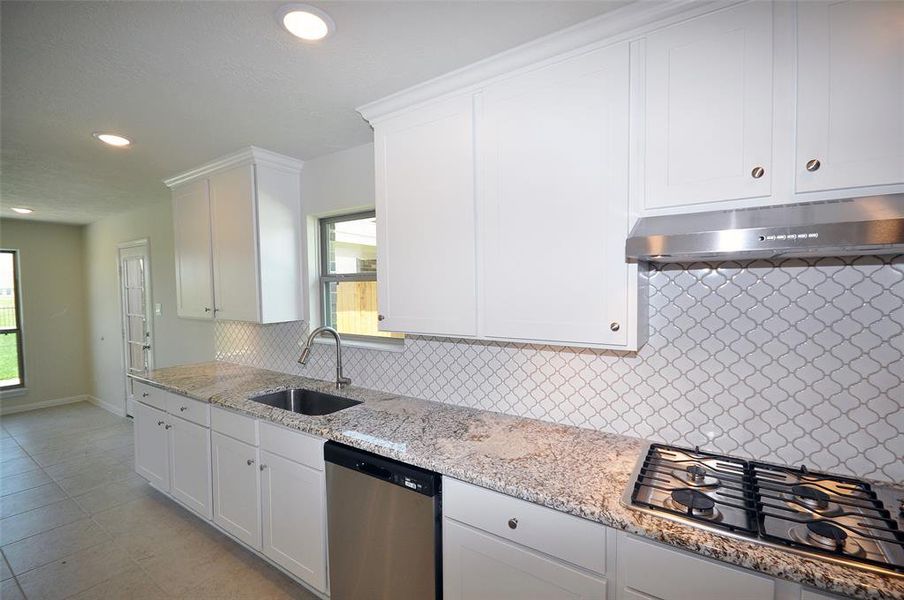 Tru White cabinets soar to the ceiling.