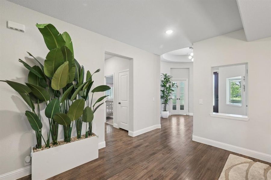 Hall featuring wood finished floors and recessed lighting Hall featuring wood finished floors and recessed lighting