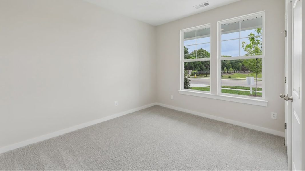 Bedroom with carpet and windows