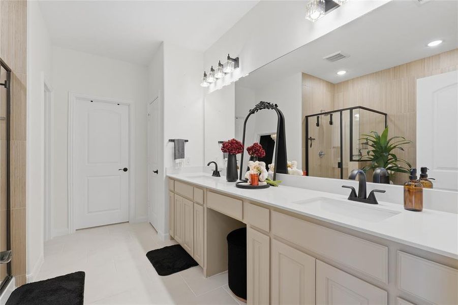 Bathroom featuring a dual vanity with white countertops, light-colored cabinetry, and matte black hardware Bathroom featuring a dual vanity with white countertops, light-colored cabinetry, and matte black hardware