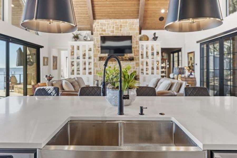 Kitchen featuring open floor plan, wood ceiling, healthy amount of natural light, french doors, and light stone counters