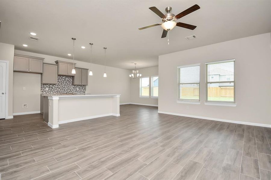 Picture yourself relaxing in this living room! Abundant natural light pours in through the large windows, complemented by recessed lighting for a bright and welcoming ambiance. *This image is from another Saratoga Home with similar floor plan and finishes, not the Brittany floorplan.*