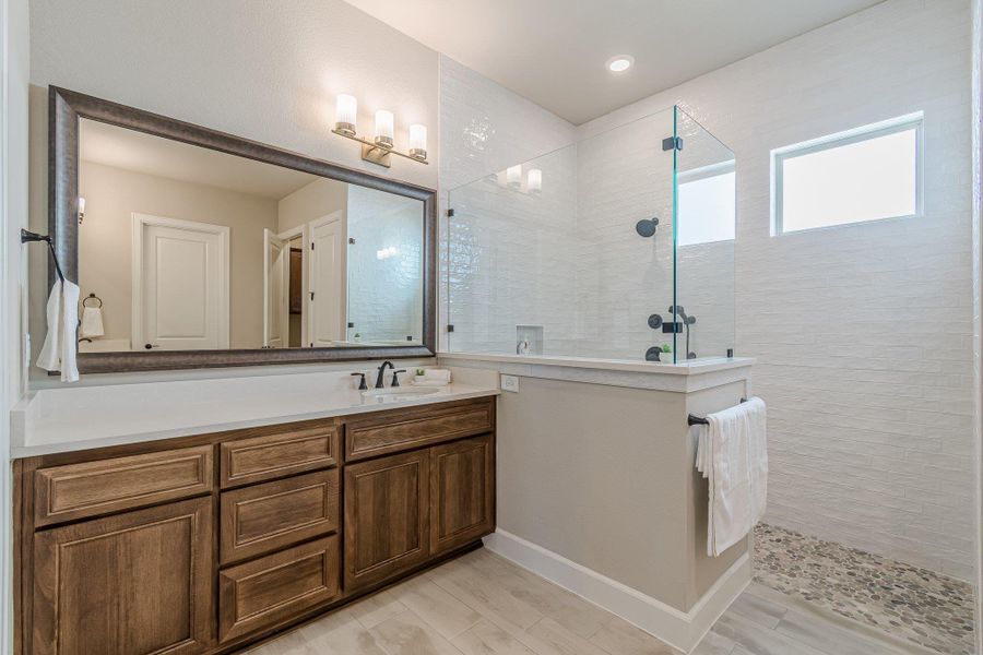 Full bath featuring a walk in shower and vanity