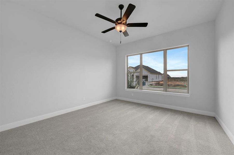 Spare room with light carpet and a ceiling fan Spare room with light carpet and a ceiling fan