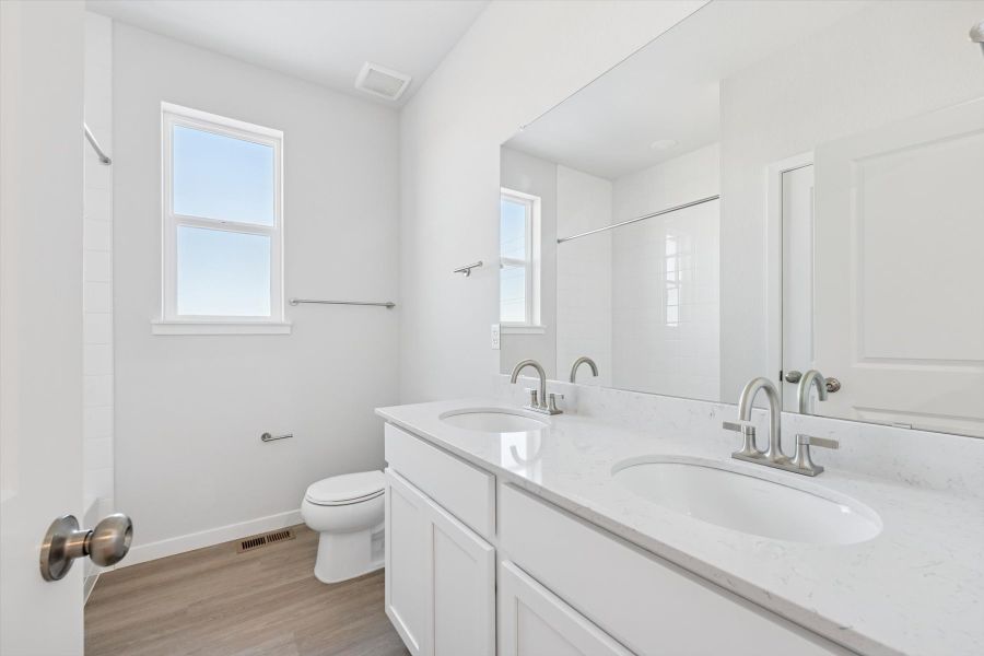 A bathroom with white cabinets. A bathroom with white cabinets.