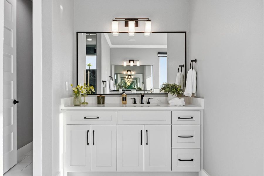 Bathroom featuring vanity and crown molding