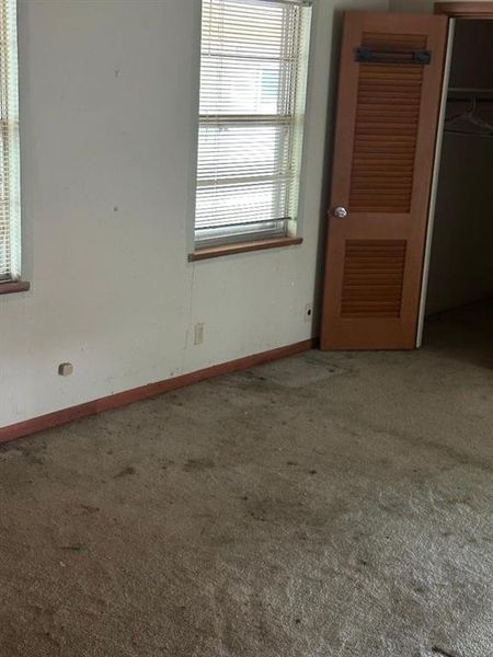 Unfurnished bedroom with carpet floors