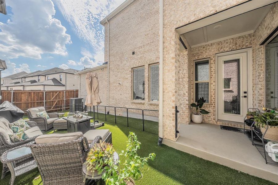View of patio featuring an outdoor living space with a fire pit and a grill