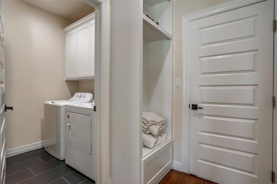 Laundry room featuring cabinets and independent washer and dryer