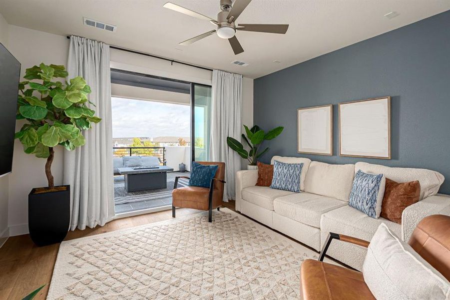 Living area with wood finished floors and ceiling fan
