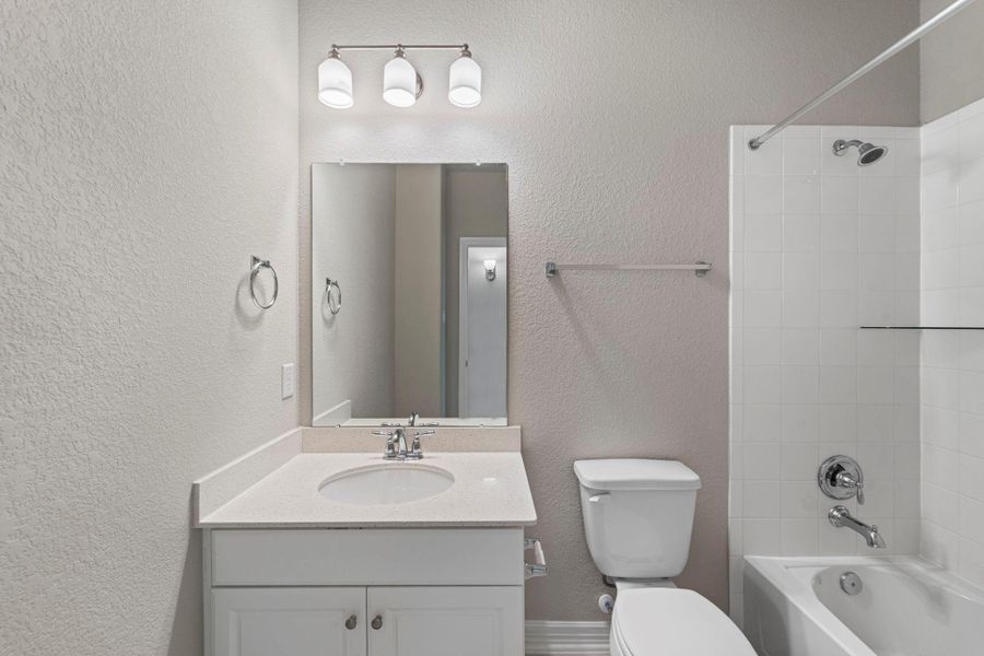 The secondary bath features tile flooring, white cabinetry and light countertops and a shower/tub combo. Perfect for accommodating any visiting family and friends. The secondary bath features tile flooring, white cabinetry and light countertops and a shower/tub combo. Perfect for accommodating any visiting family and friends.