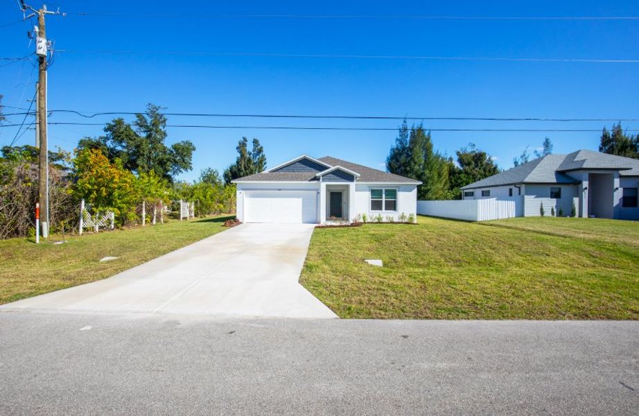 Front exterior of a new home in Cape Coral, Cape Coral, FL, highlighting curb appeal (Image 2). Front exterior of a new home in Cape Coral, Cape Coral, FL, highlighting curb appeal (Image 2).