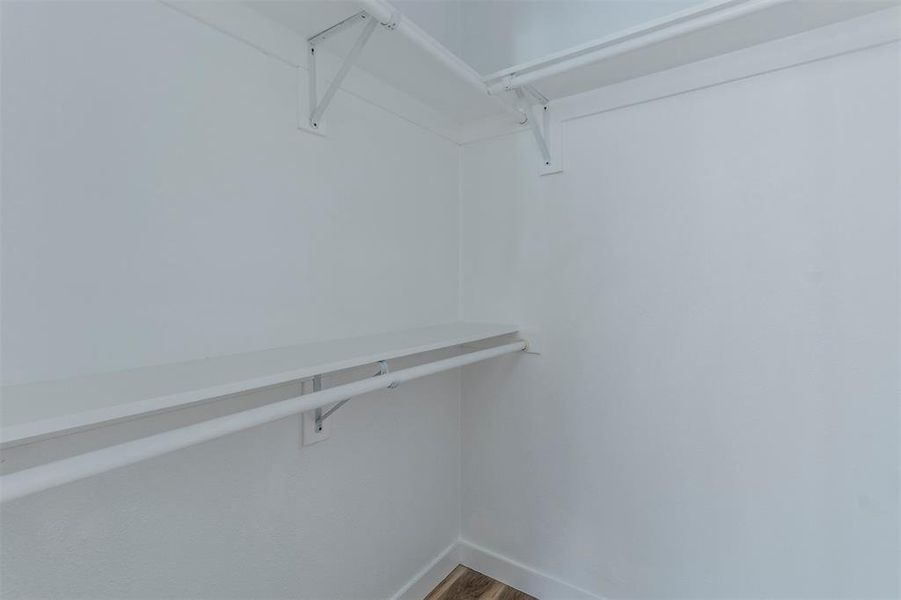 Walk in closet featuring wood finished floors Walk in closet featuring wood finished floors