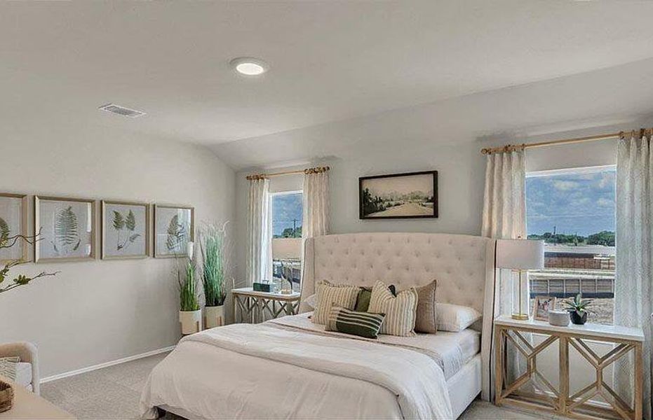 Bedroom featuring carpet floors, baseboards, and lofted ceiling Bedroom featuring carpet floors, baseboards, and lofted ceiling