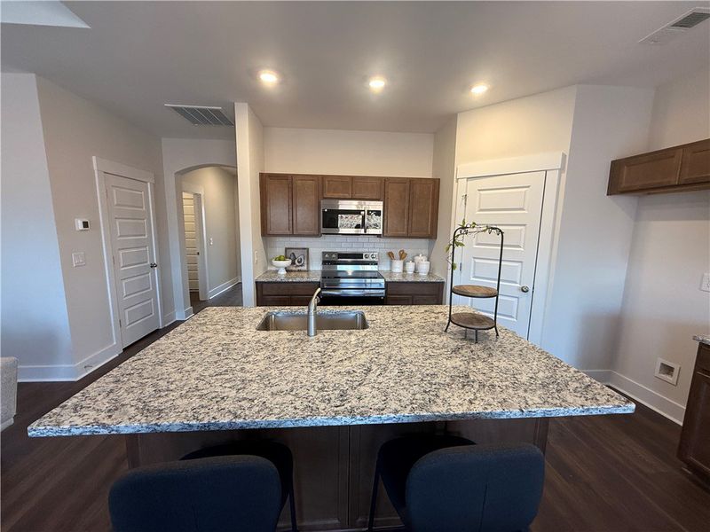 This modern kitchen features a spacious island, sl
