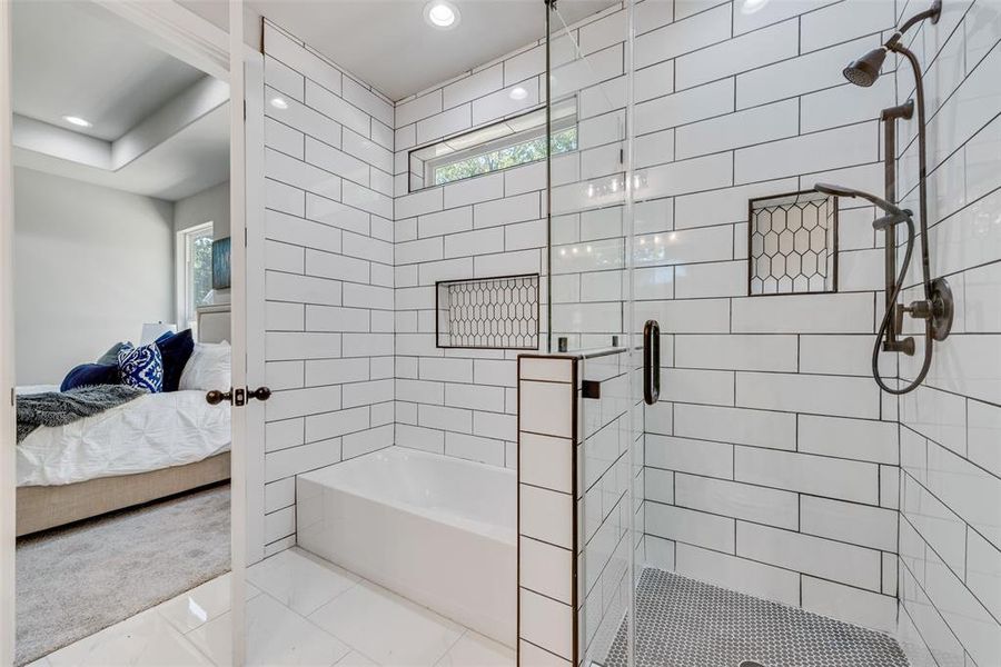 Bathroom featuring shower with separate bathtub