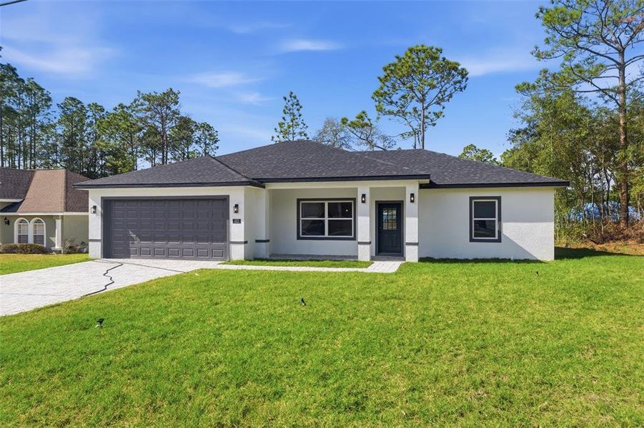 Front exterior of a new home in , Citrus Springs, FL, highlighting curb appeal (Image 18). Front exterior of a new home in , Citrus Springs, FL, highlighting curb appeal (Image 18).