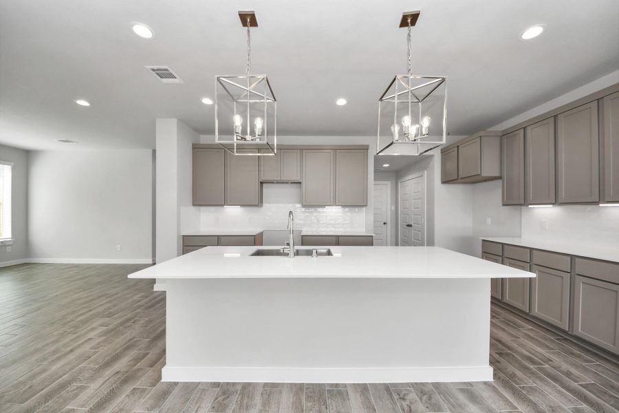 This kitchen is by far any chef’s dream! This spacious kitchen features high ceilings, stained wood cabinets, granite countertop, SS appliances, modern tile backsplash, recessed lighting, extended counter space, granite kitchen island with double sink, and space for breakfast bar, and a walk-in pantry all overlooking your huge family room.