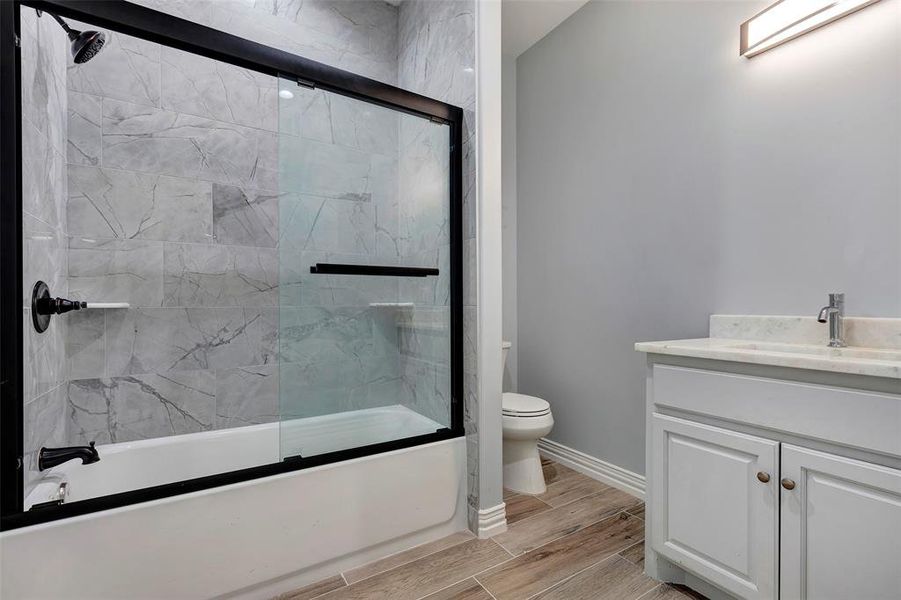 Hall bath with quartz counter tops and glass door