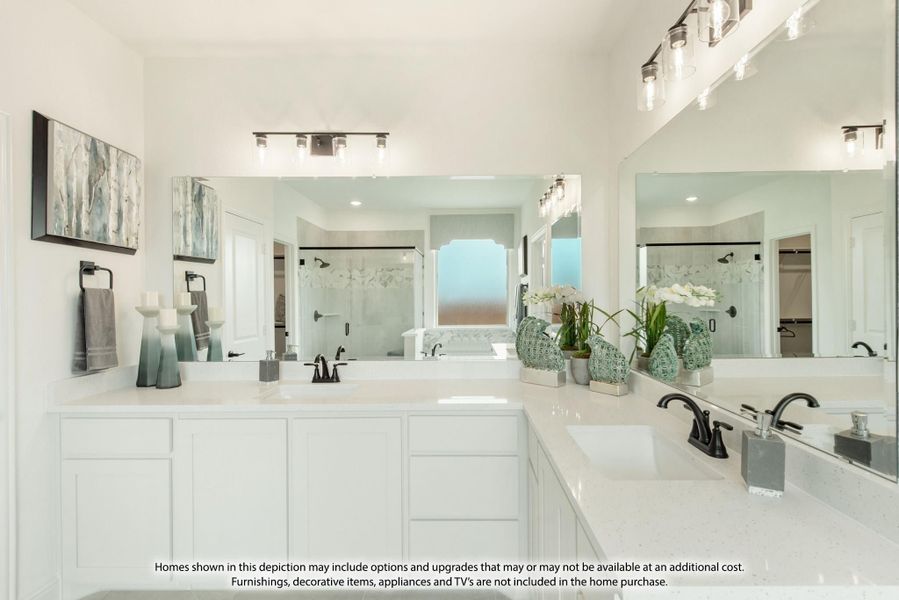 Master bathroom with double vanity, white cabinets, quartz countertops, and glass-enclosed shower in background.