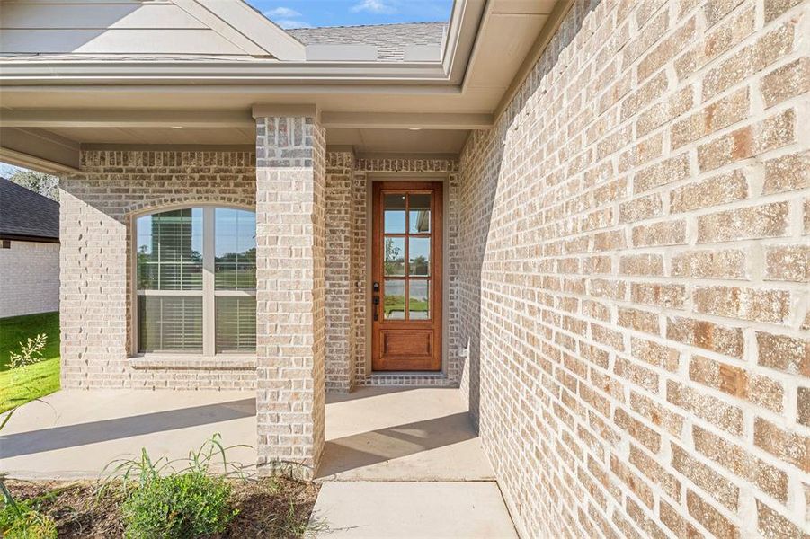 Doorway to property with brick siding