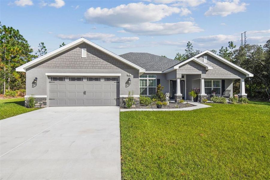 Front exterior of a new home in Sugarmill Woods, Homosassa, FL, highlighting curb appeal (Image 27).