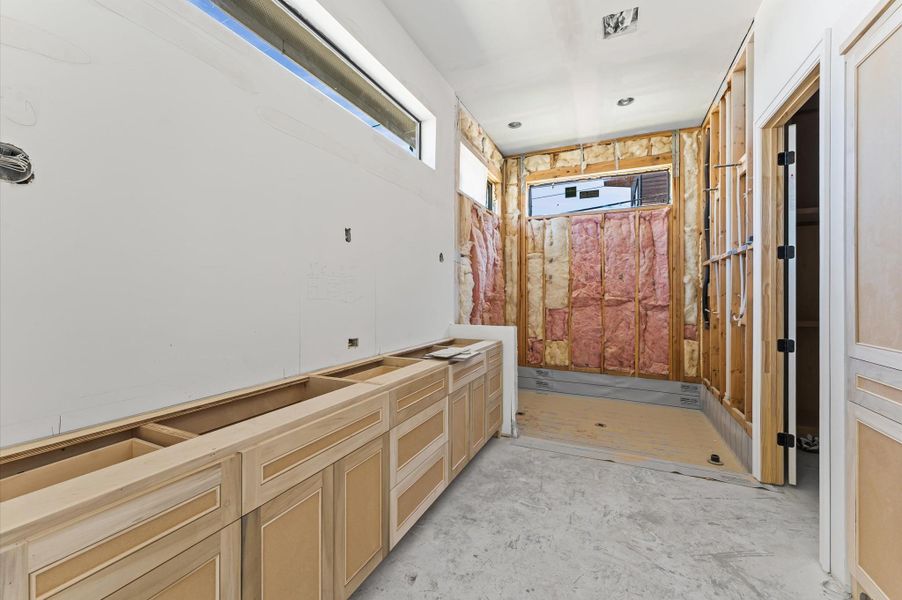 Primary bath offers large walk in shower, stand alone soaking tub and plenty of storage.