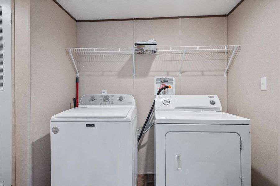 Functional utility hookups pair with durable flooring to create a practical home chore station.