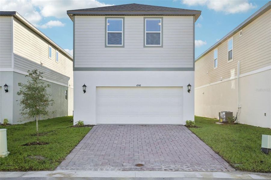 Front exterior of a new home in The Meadow at Crossprairie Bungalows, St. Cloud, FL, highlighting curb appeal (Image 21).