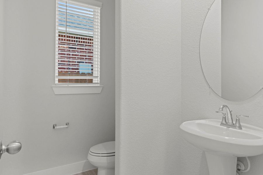 The convenient half bath on the main floor is perfect for guests! This beautifully finished space features a sleek pedestal sink, contemporary lighting, and soft natural tones that complement the home’s bright and airy feel. The convenient half bath on the main floor is perfect for guests! This beautifully finished space features a sleek pedestal sink, contemporary lighting, and soft natural tones that complement the home’s bright and airy feel.