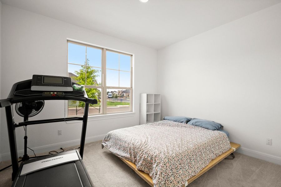 Carpeted bedroom featuring baseboards Carpeted bedroom featuring baseboards